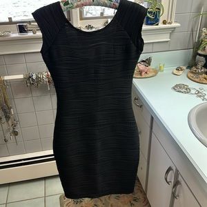 Simple black calf length bodycon dress.